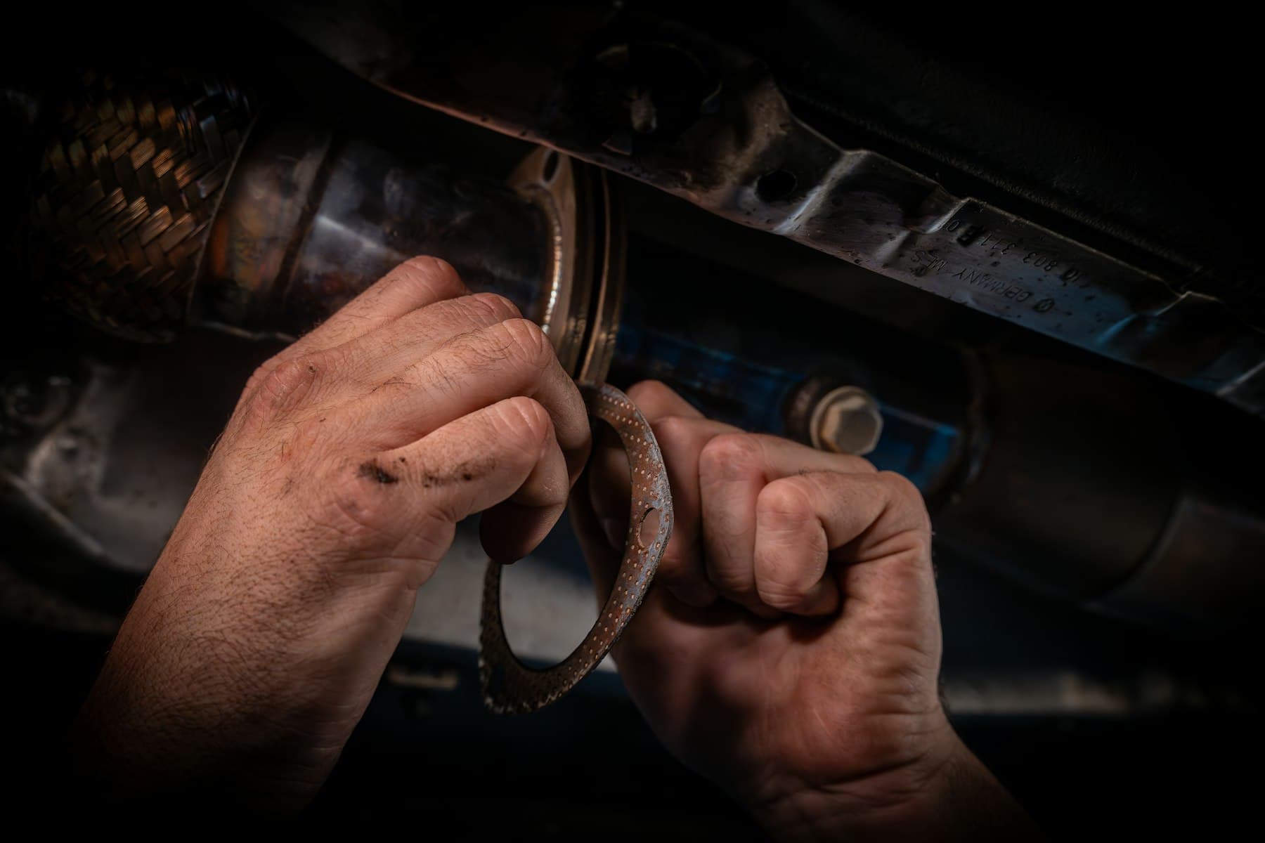 Close-up of an engineer's hands working on engine components during an overhaul